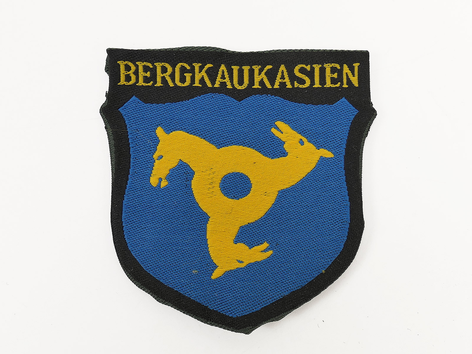 Field jacket sleeve badge: CAUCASUS MOUNTAINS Volunteer Division, Waffen SS – woven, folded and turned back