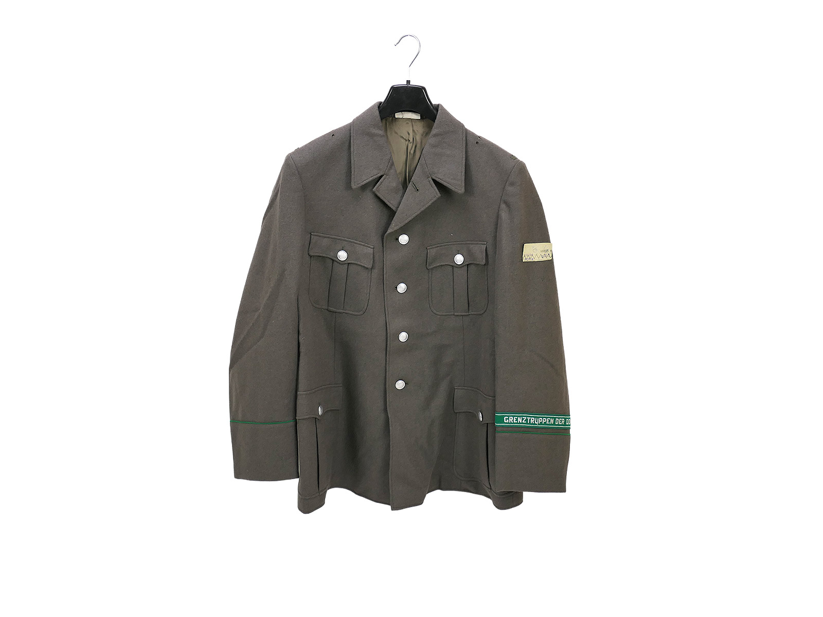 Original GDR NVA Border Troops uniform with sleeve band and cap badge, complete with label