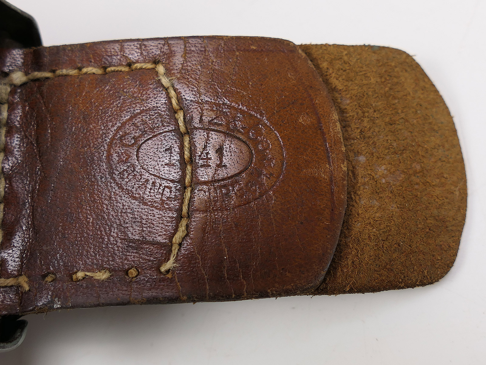 Wehrmacht belt buckle by C.W. Motz, 1941, Brandenburg/Havel, with leather tongue – COLLECTION BATTLE WORN