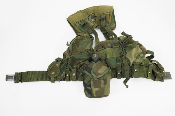 US Army assault pack on pistol belt set with various pouches and water bottle